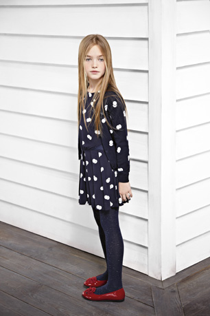 little girl wears Armani Junior blue and white dress
