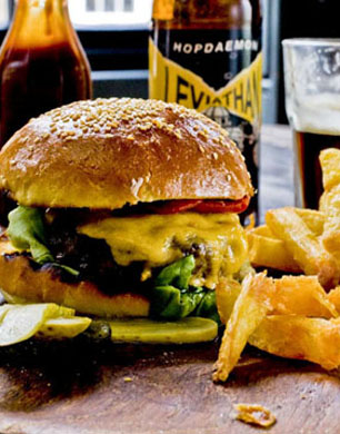 Bukowski Grill Burger with chips and a beer 