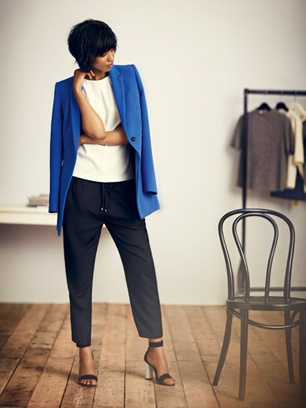 model wears blue coat and black trousers for John Lewis Womens Modernist trend 