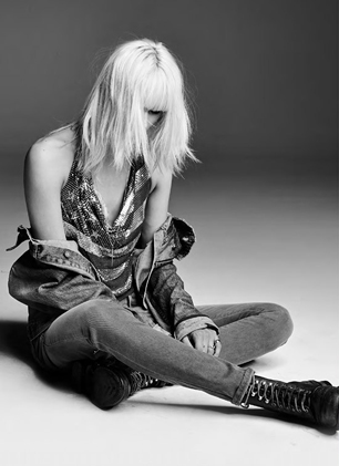 model on floor wearing sequin top and jeans 