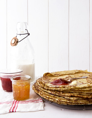 Pile of pancakes and jars of jam